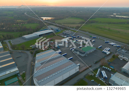 Aerial view of blue photovoltaic solar panels mounted on industrial building roof for producing green ecological electricity. Production of sustainable energy concept 132749985