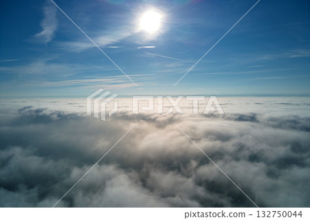 Aerial view from high altitude of earth covered with puffy rainy clouds forming before rainstorm Aerial view from high altitude of earth covered with puffy rainy clouds forming before rainstorm 132750044