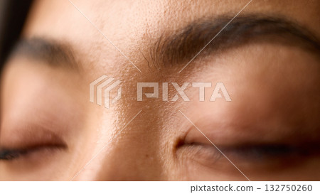 Macro of closed eyes showing calm relaxation and natural skin softness Macro of closed eyes showing calm relaxation and natural skin softness 132750260