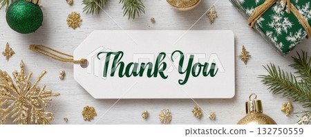 paper tag with words thank you on christmas background with green and golden decoration 132750559