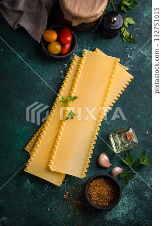 Uncooked lasagna pasta with cooking ingredient 132751015