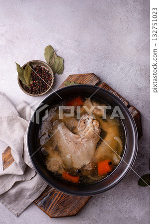 Chicken broth soup or bouillon in pan 132751023