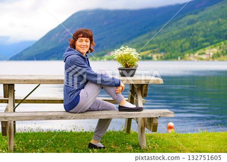 Woman tourist relax on fjord shore, Norway 132751605