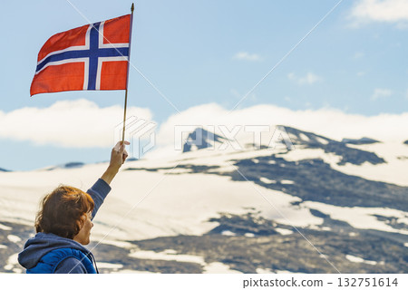 Tourist with norwegian flag in mountains Tourist with norwegian flag in mountains 132751614