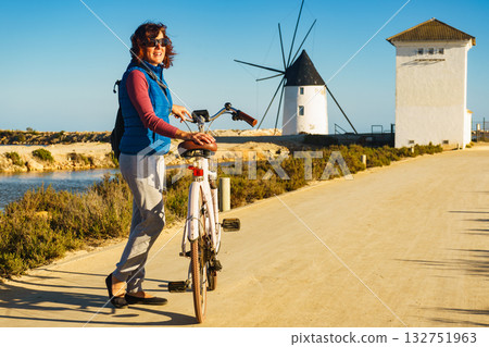 Woman with bike at San Pedro del Pinatar park, Spain Woman with bike at San Pedro del Pinatar park, Spain 132751963