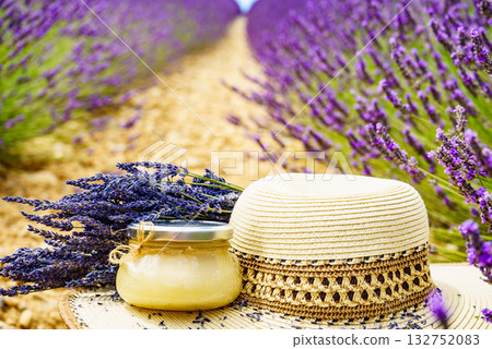 Summer hat and jar with honey at lavender field. Holidays in France. Summer hat and jar with honey at lavender field. Holidays in France. 132752083