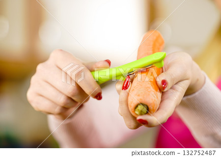 Woman peeling carrot vegetable 132752487