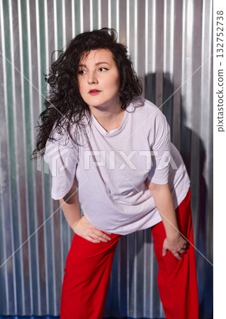 woman pondering image, contemplative woman in redpants, woman with thoughtful expression and red 132752738
