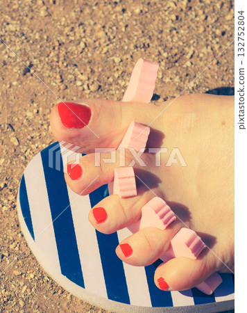 Woman drying her nail polish after pedicure 132752804