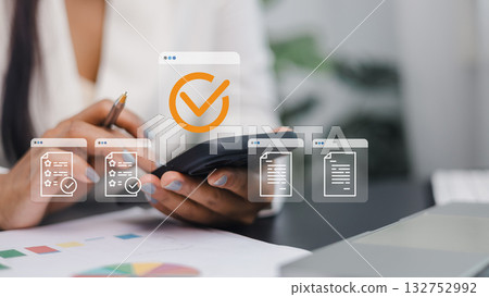 Businesswoman Using Smartphone for Digital Document Management and Task Approval Businesswoman Using Smartphone for Digital Document Management and Task Approval 132752992