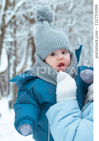 Baby in Winter Clothing in Snowy Forest 132753099