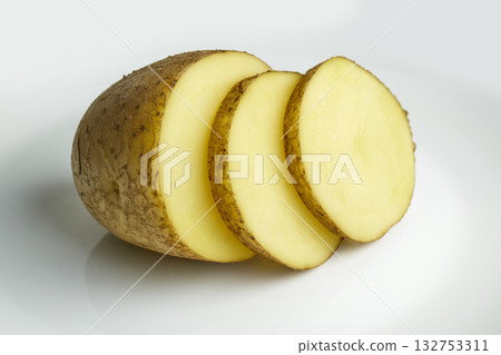 Sliced yellow potato pieces on a clean surface. High quality photo Sliced yellow potato pieces on a clean surface. High quality photo 132753311