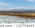 First snowfall and rural scenery in the Furano Basin overlooking the Tokachi Mountain Range 132754449