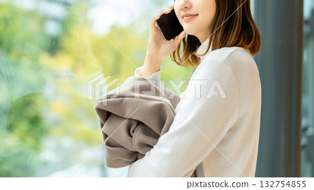Young woman making a call on her smartphone Young woman making a call on her smartphone 132754855