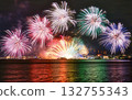 Fireworks reflected on the water and boats on the lake 132755343