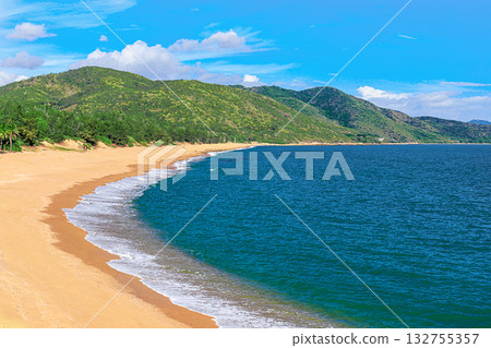 A picturesque view of the beach and mountain at Nianshan Park, Sanya, China. A picturesque view of the beach and mountain at Nianshan Park, Sanya, China. 132755357