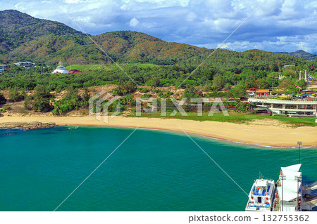 A picturesque view of the beach and mountain at Nianshan Park, Sanya, China. 132755362