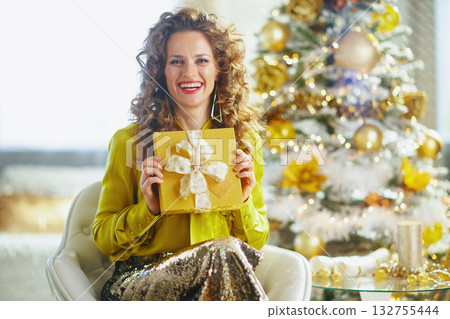 Smiling Woman with Green Blouse Holds Christmas Gift Smiling Woman with Green Blouse Holds Christmas Gift 132755444