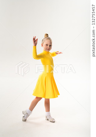 Young dancer with cochlear implant performing dance pose. Strength, adaptability, and inclusion merge in a story of overcoming hearing barriers through art, discipline, and body control. Young dancer with cochlear implant performing dance pose. Strength, adaptability, and inclusion merge in a story of overcoming hearing barriers through art, discipline, and body control. 132755457