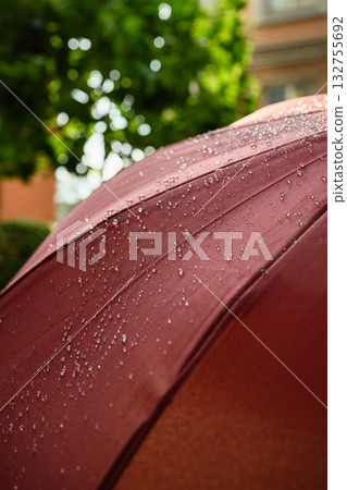 Water droplets on red umbrella after rain outdoors. 132755692