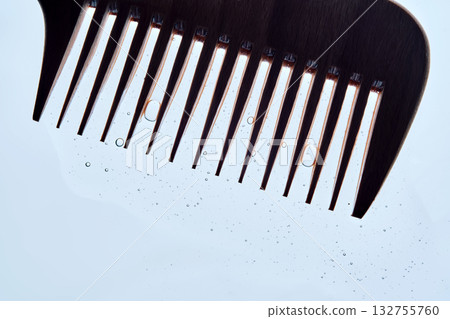 A comb with hair serum. The photo shows the texture of the cosmetic product. 132755760