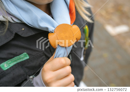 Boy Scout Anniversary Week, Scout Sunday, Scout Sabbath Young caucasian girl with scouting uniform and neckerchief slide 132756072