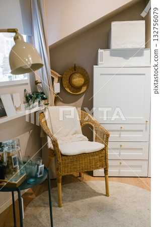 Cozy modern living space with wicker chair and neutral decor 132756079