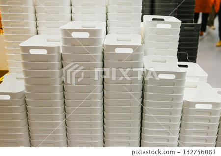 Stacked white plastic storage bins in warehouse setting Stacked white plastic storage bins in warehouse setting 132756081
