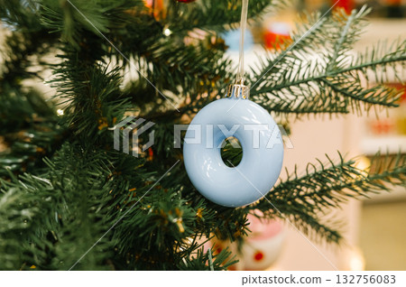 Blue porcelain ornament on green christmas tree branch close-up Blue porcelain ornament on green christmas tree branch close-up 132756083