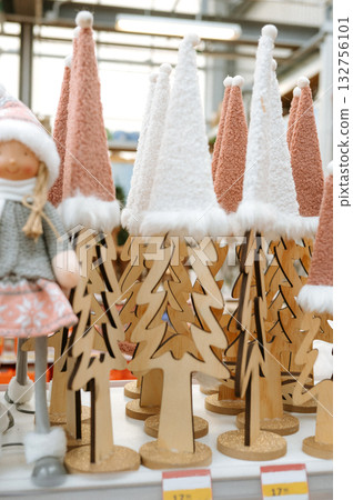 Whimsical christmas display with woolen hats and wooden trees in festive setting 132756101
