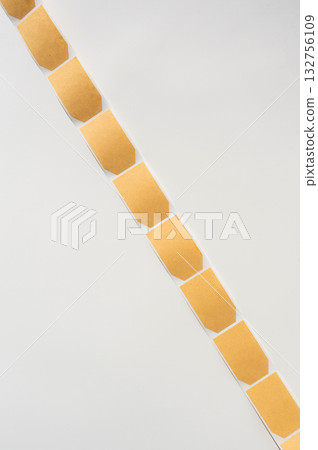 Empty tea bags in neat vertical arrangement on white background 132756109