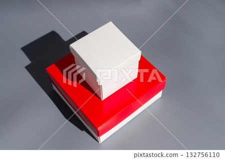 White and red gift boxes on gray background with shadow White and red gift boxes on gray background with shadow 132756110