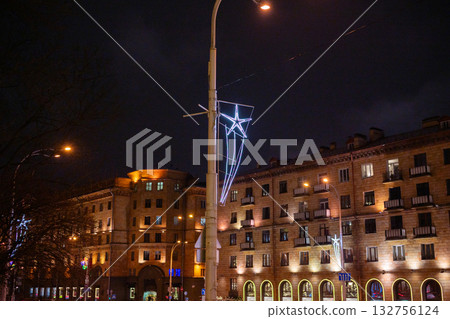Nighttime cityscape with illuminated buildings and street decorations Nighttime cityscape with illuminated buildings and street decorations 132756124