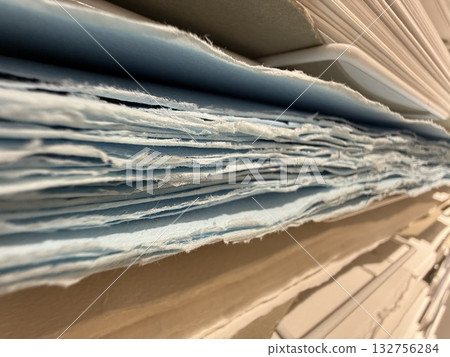 Stacks of blue and white textured paper in close-up view suitable for abstract background Stacks of blue and white textured paper in close-up view suitable for abstract background 132756284