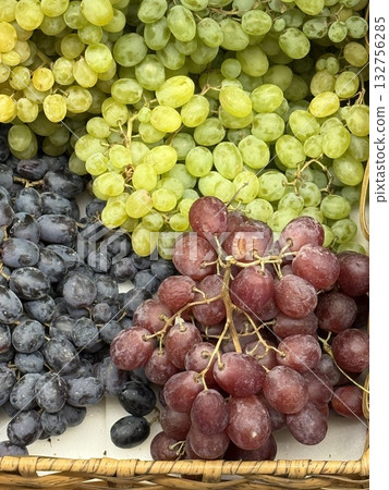 Assorted grapes in basket with red, green, and black varieties, perfect for fruit backgrounds 132756285