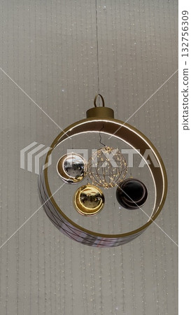 Christmas ornament with reflective spheres hanging as festive decoration in vertical format Christmas ornament with reflective spheres hanging as festive decoration in vertical format 132756309