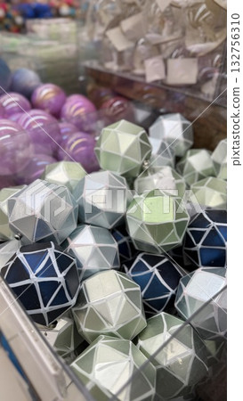 Geometric Christmas ornaments in blue and green tones in a close-up view for festive background Geometric Christmas ornaments in blue and green tones in a close-up view for festive background 132756310