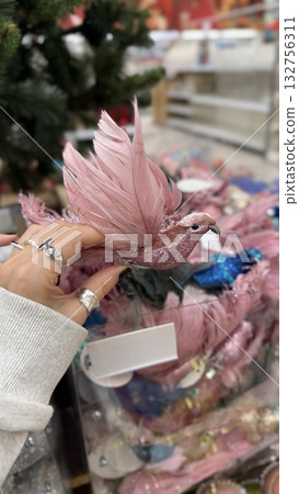 Christmas ornament featuring a pink bird with glitter used as festive decoration Christmas ornament featuring a pink bird with glitter used as festive decoration 132756311