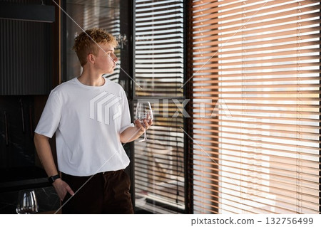 Expressive portrait of young man with somber mood and artistic 132756499
