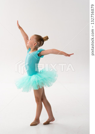 Girl ballerina with hearing implant raising arms gracefully. Expression of equality, empowerment, and sound restoration through classical dance and technology. 132756879