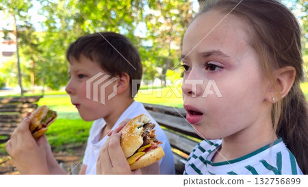 school children eat big hamburger, kids eat burger park, group children friends eat cutlet bun, Youngsters enjoy fast food in green park, group eating burgers and hotdogs, friendship and good times school children eat big hamburger, kids eat burger park, group children friends eat cutlet bun, Youngsters enjoy fast food in green park, group eating burgers and hotdogs, friendship and good times 132756899