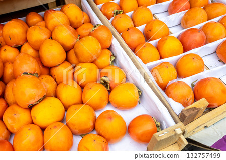 Organic ripe persimmon ready for sale at the farmers market Organic ripe persimmon ready for sale at the farmers market 132757499