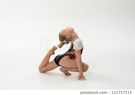 Little gymnast with cochlear implant stretching in backbend pose, copy space. Overcoming hearing challenges through art, flexibility, and emotional freedom in rhythmic gymnastics. Little gymnast with cochlear implant stretching in backbend pose, copy space. Overcoming hearing challenges through art, flexibility, and emotional freedom in rhythmic gymnastics. 132757515