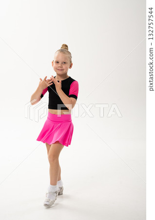 Little girl with hearing implant dancing in black and pink costume. Overcoming deafness with technology, creativity, and the expressive joy of inclusive childhood art. 132757544