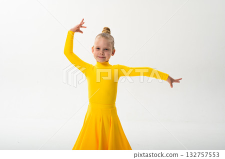 Young dancer with cochlear implant performing dance pose. Strength, adaptability, and inclusion merge in a story of overcoming hearing barriers through art, discipline, and body control. 132757553