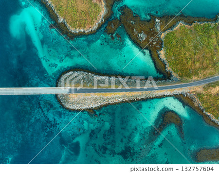 Aerial view of bridge, sea with waves and stones at sunset 132757604