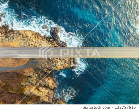 Aerial view of bridge, sea with waves and stones at sunset Aerial view of bridge, sea with waves and stones at sunset 132757610