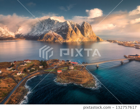 Aerial view of Reine village, fjords and snowy mountains Aerial view of Reine village, fjords and snowy mountains 132757617