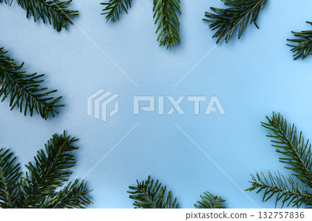 Christmas fir branches on blue background Christmas fir branches on blue background 132757836