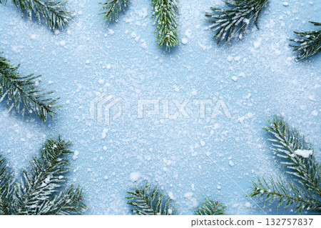 Christmas Snowy fir branches on blue background 132757837